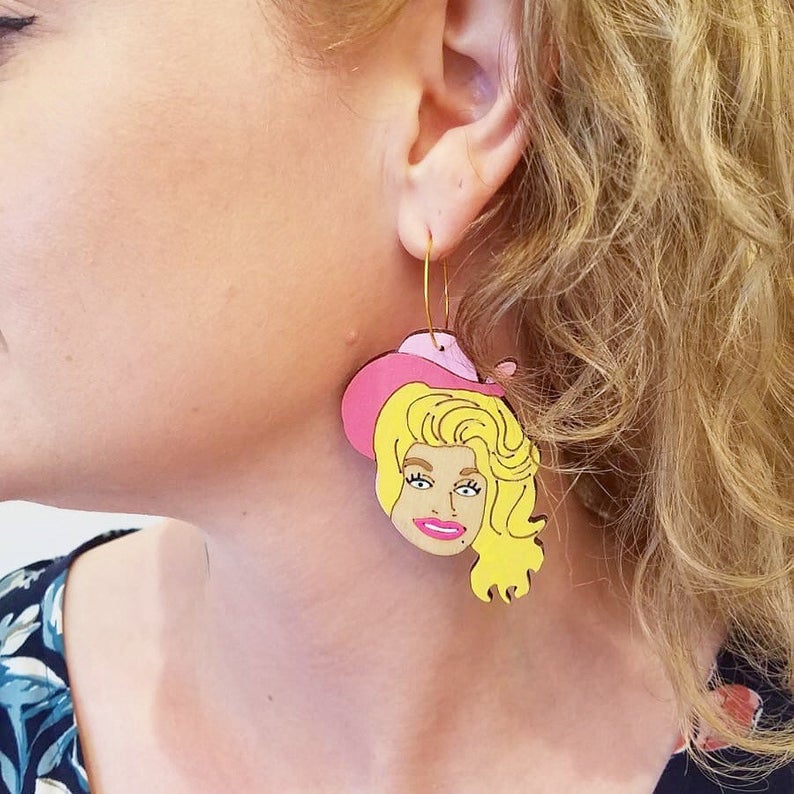 Dolly Parton wearing cowgirl hat hand painted hoop dangle earrings by Le Chic Miami